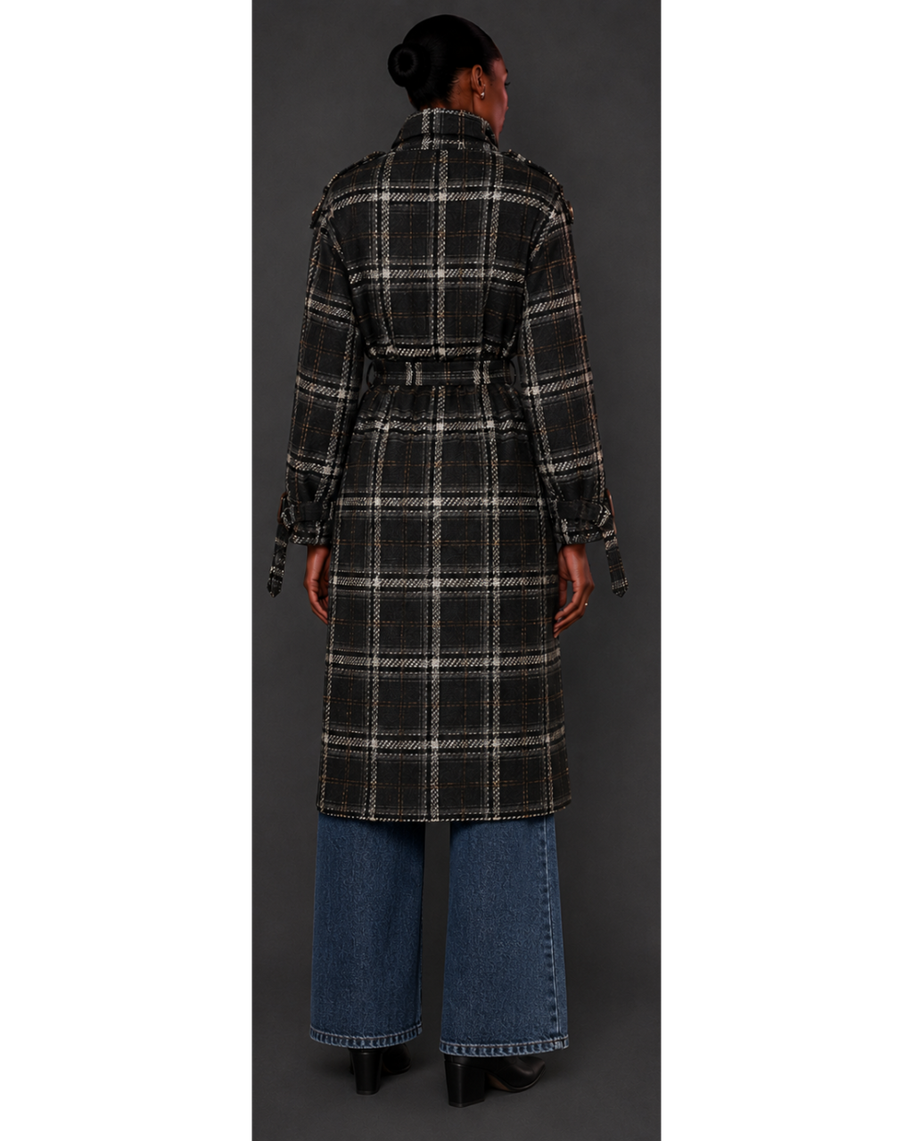 Person wearing a plaid coat with a plain background
