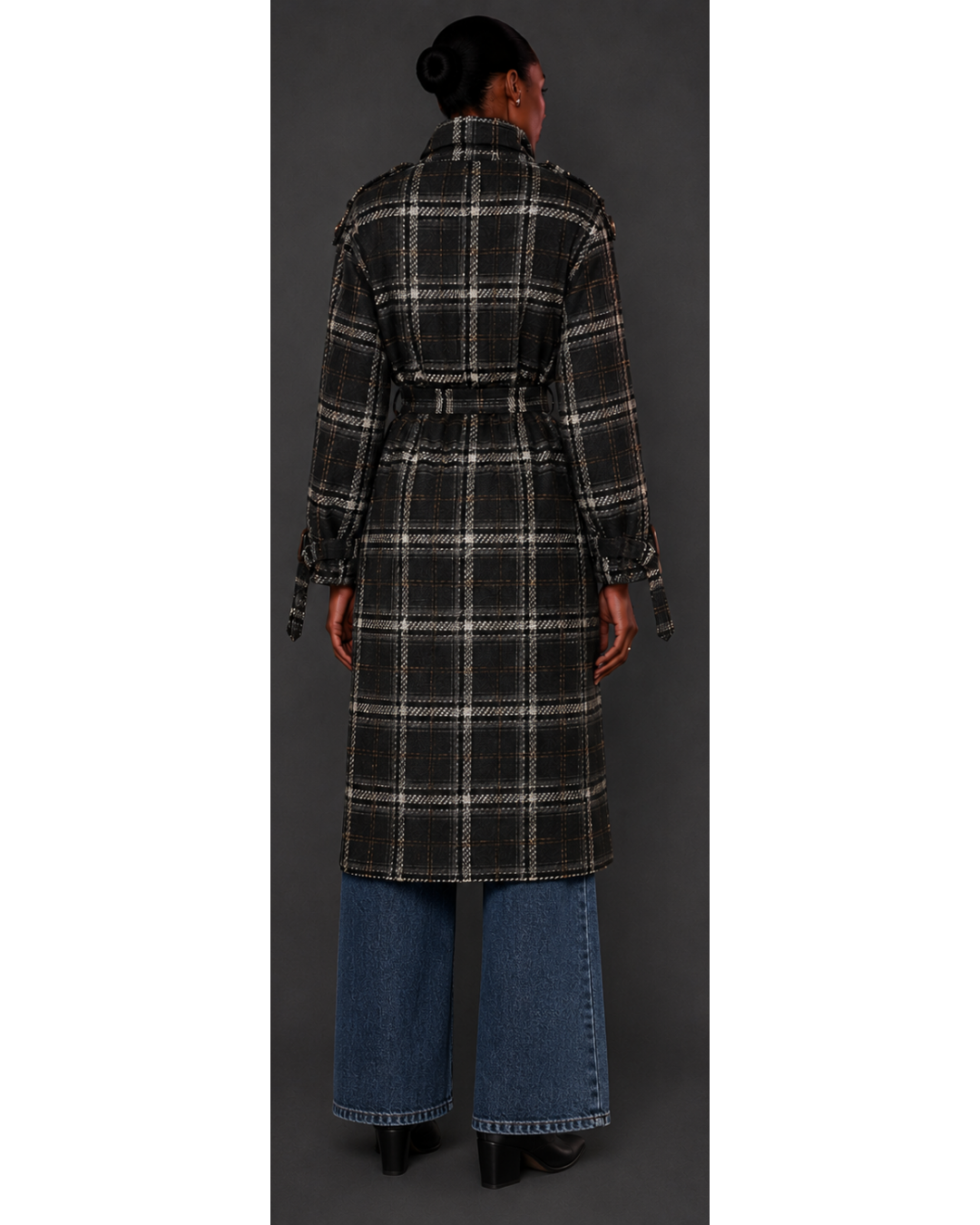Person wearing a plaid coat with a plain background