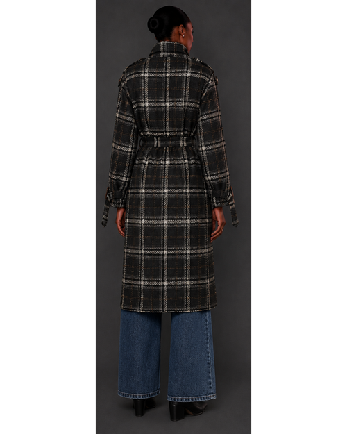 Person wearing a plaid coat with a plain background