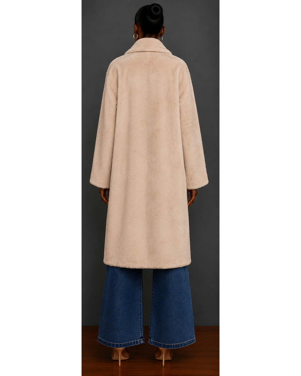 Back view of woman wearing a beige coat with black buttons against a gray background