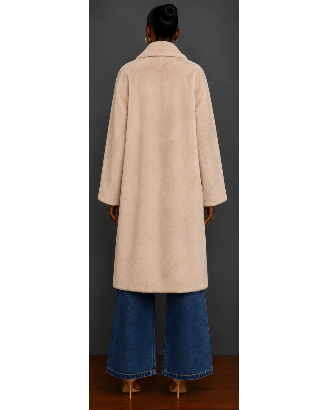 Back view of woman wearing a beige coat with black buttons against a gray background