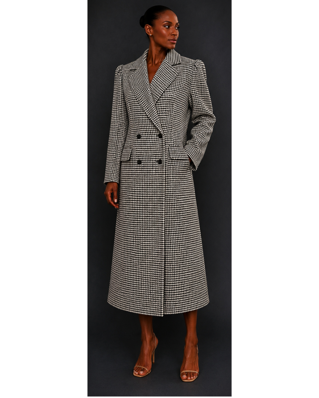 Woman wearing a long, houndstooth coat against a dark background