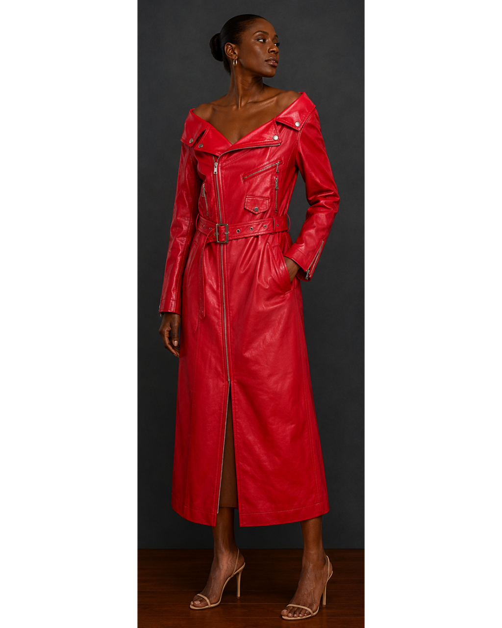 Red leather moto style trench coat dress worn by a model on a gray background