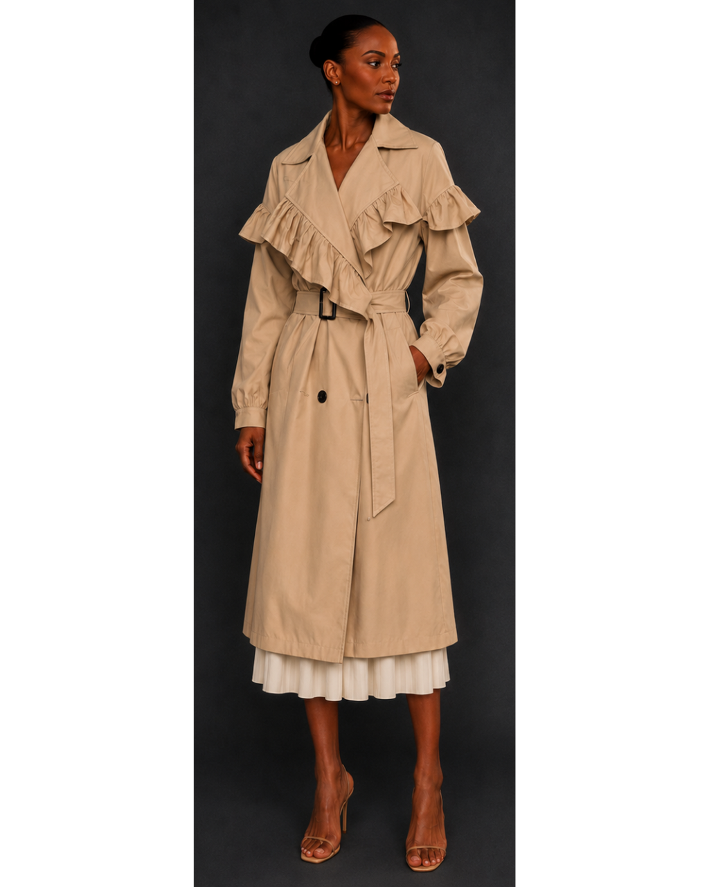 Woman wearing a beige trench coat with ruffled details on a black background