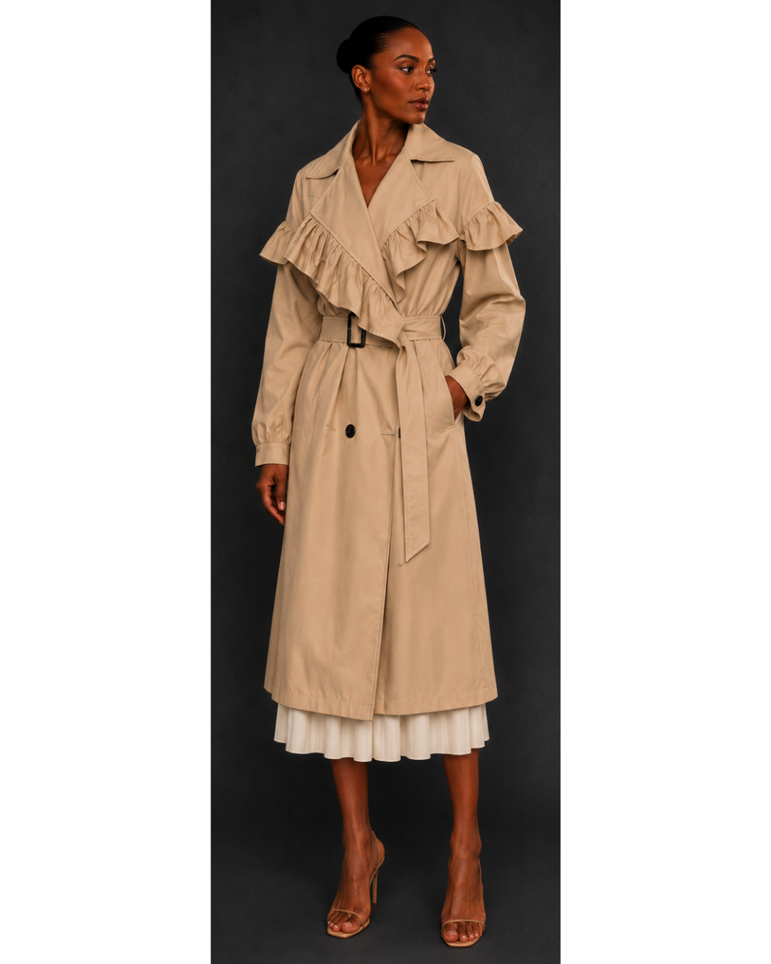 Woman wearing a beige trench coat with ruffled details on a black background