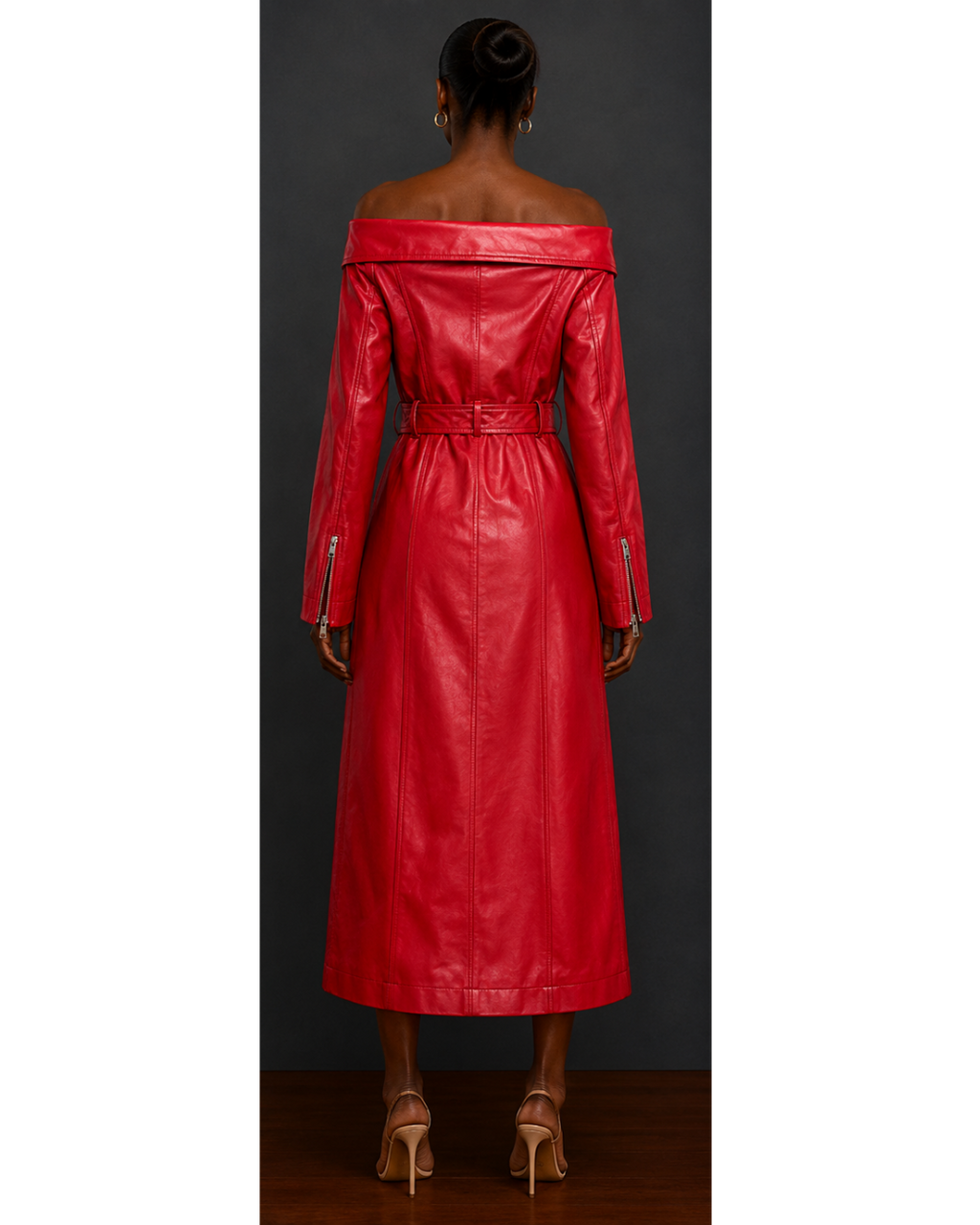 Red leather moto style trench coat dress worn by a model against a dark background
