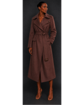 Woman wearing a brown trench coat against a dark background