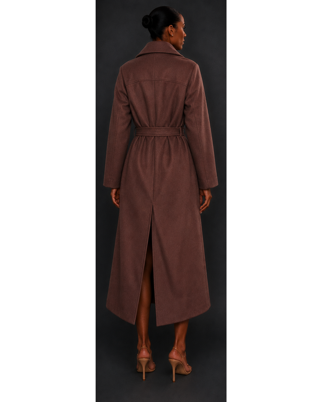 Woman wearing a long brown coat with a belt, standing against a dark background.