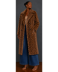 Front view of woman wearing a leopard print faux fur coat and blue jeans against a gray background