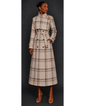 Woman wearing a plaid trench coat against a dark background
