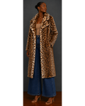 Woman wearing a leopard print coat and blue jeans against a neutral background